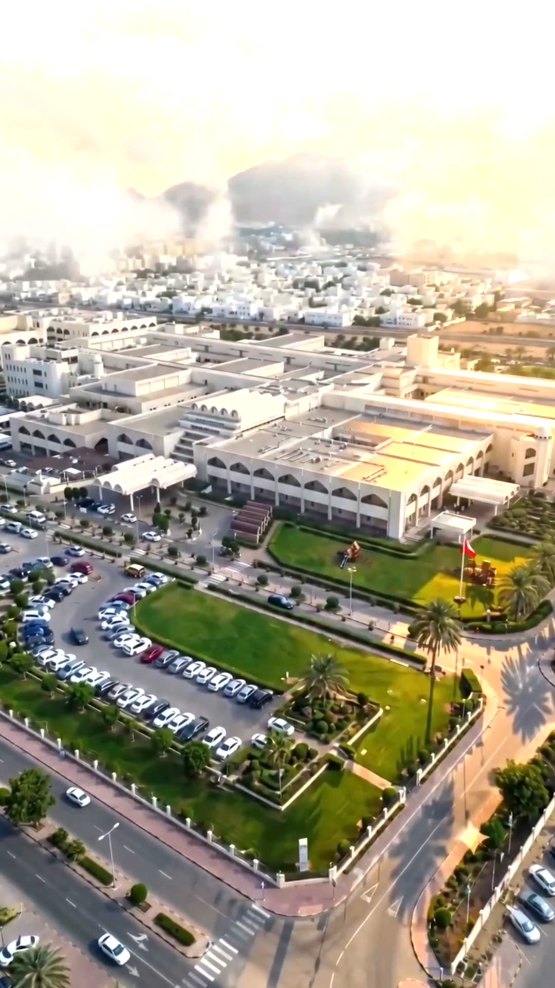 Aerial view of Muscat and The Royal Hospital at golden hour